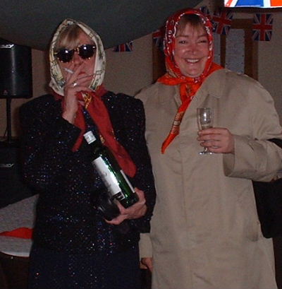 The Queen (dressed for the damp weather) and her sister Margaret