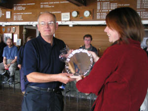 David Warren receives trophy from Kayla